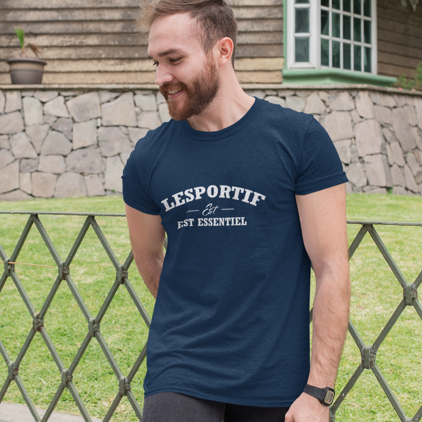 Man wearing a navy blue 'Lesportif' t-shirt outdoors.