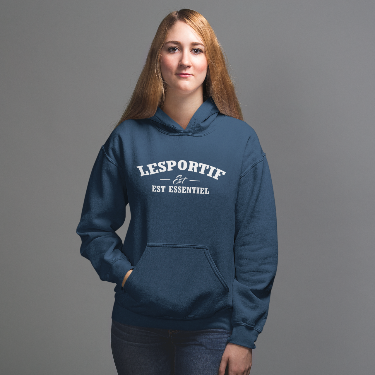 Person wearing a blue Lesportif hoodie on a gray background